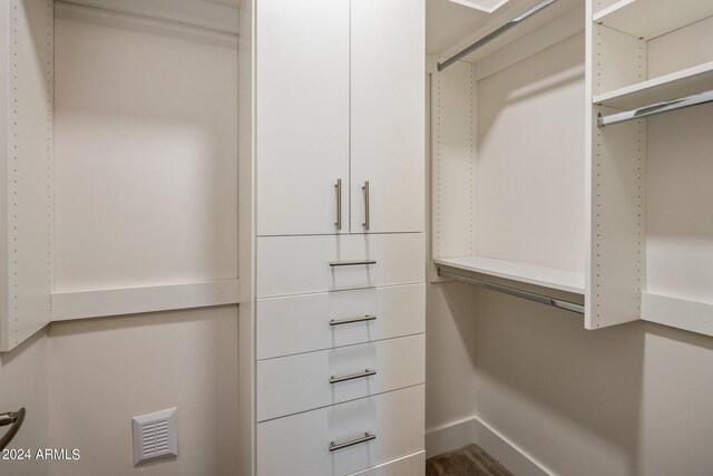 bathroom featuring a shower with shower door and vanity