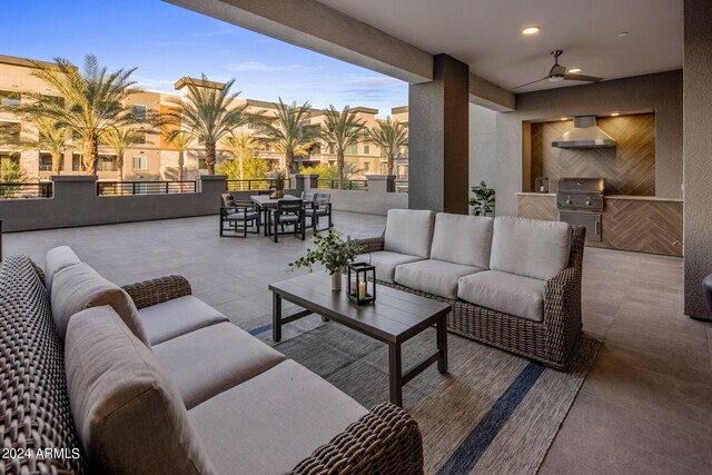 view of patio featuring a balcony, an outdoor living space, and ceiling fan