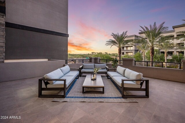 patio terrace at dusk featuring an outdoor living space