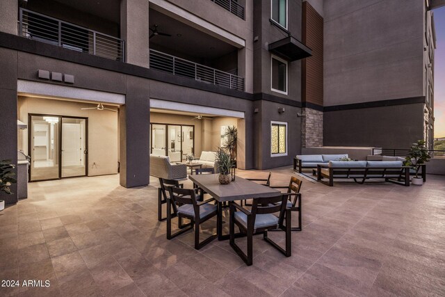 patio terrace at dusk featuring an outdoor hangout area