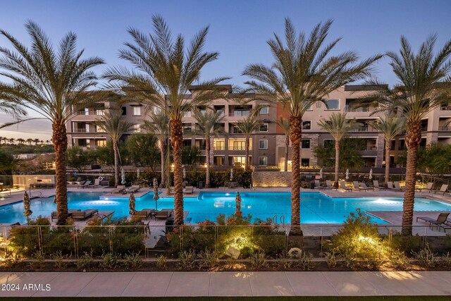 view of pool at dusk