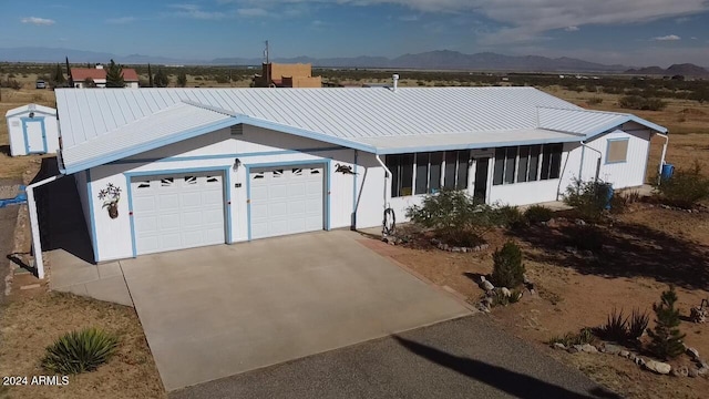 view of front of house with a garage and a mountain view