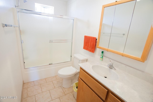 full bathroom featuring tile patterned flooring, vanity, combined bath / shower with glass door, and toilet