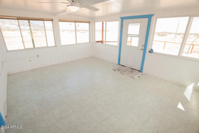 unfurnished sunroom with lofted ceiling and ceiling fan