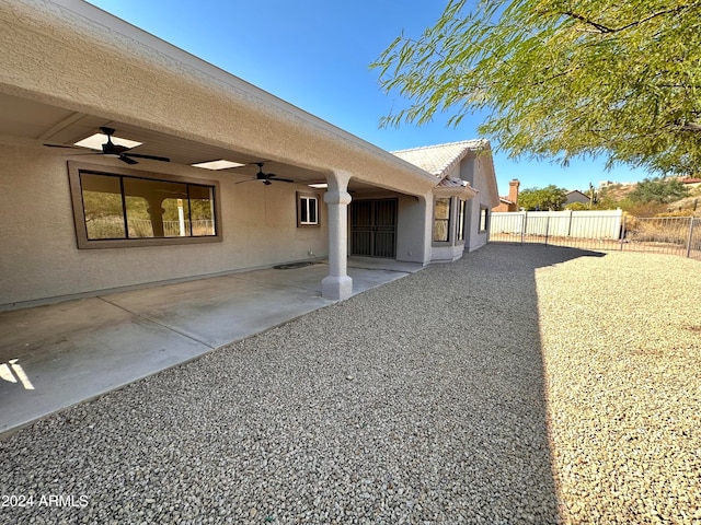 rear view of house with a patio area and ceiling fan