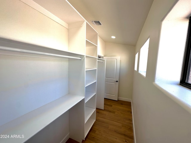 spacious closet with hardwood / wood-style floors