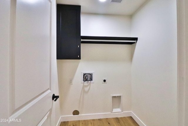 clothes washing area featuring washer hookup, wood-type flooring, hookup for an electric dryer, and cabinets