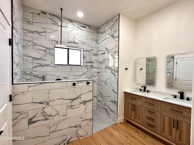 bathroom featuring vanity, hardwood / wood-style floors, and tiled shower