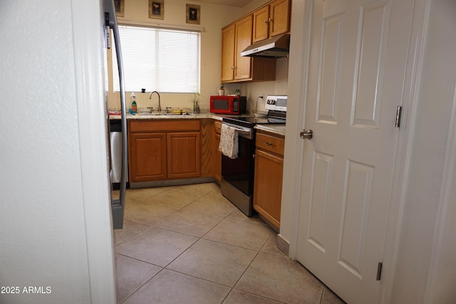 1670 W Bitter Orange St, Tucson, AZ 85705 - kitchen featuring stainless steel range with electric cooktop, a sink, under cabinet range hood, light tile patterned floors, and brown cabinets
