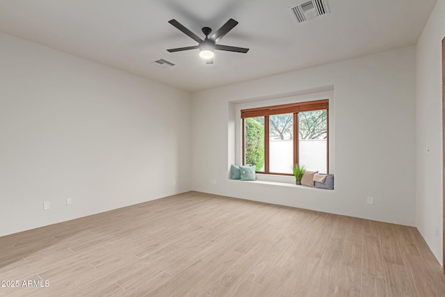 spare room featuring light wood-type flooring and ceiling fan