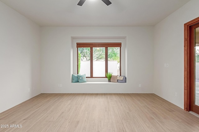 empty room featuring ceiling fan and light hardwood / wood-style flooring