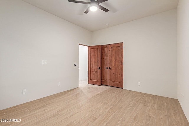 empty room featuring ceiling fan and light hardwood / wood-style floors