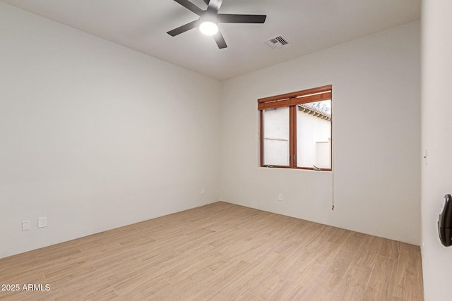 empty room with ceiling fan and light wood-type flooring