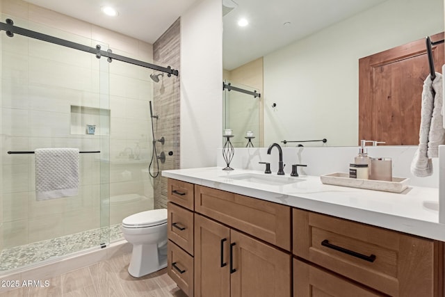 bathroom with vanity, toilet, and an enclosed shower