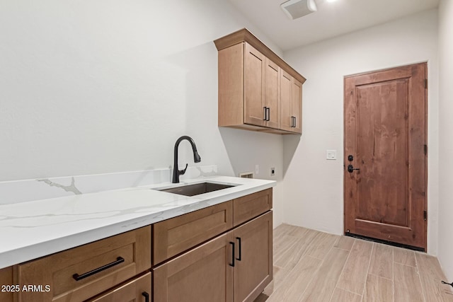 washroom with cabinets, hookup for a washing machine, electric dryer hookup, and sink