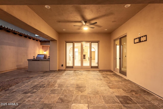 interior space with ceiling fan and french doors