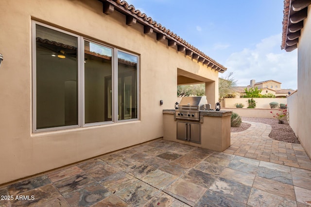 view of patio / terrace featuring an outdoor kitchen and area for grilling