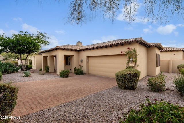 mediterranean / spanish-style home with a garage