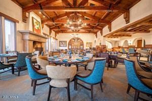 dining room with lofted ceiling with beams, a notable chandelier, and wood ceiling