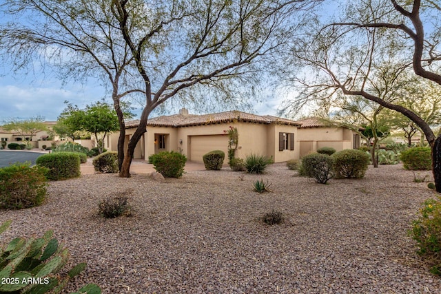 mediterranean / spanish-style home with a garage