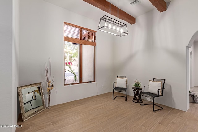 living area with beam ceiling