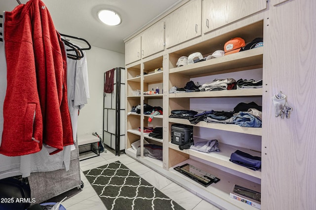 spacious closet featuring light tile patterned floors