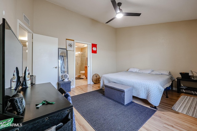 bedroom with ceiling fan, light hardwood / wood-style floors, and ensuite bathroom