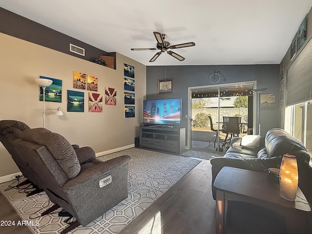 living room featuring ceiling fan, vaulted ceiling, and hardwood / wood-style flooring