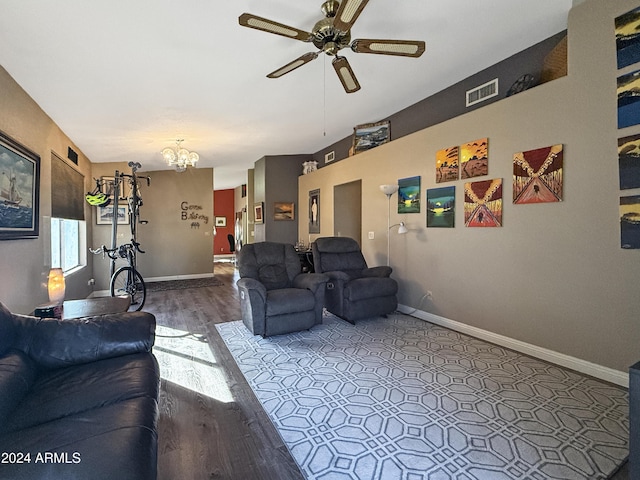 living room featuring ceiling fan with notable chandelier