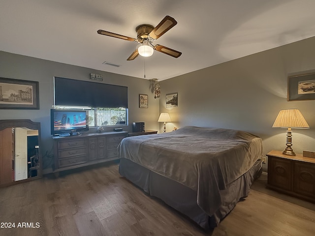 bedroom with ceiling fan and dark wood-type flooring