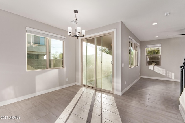 interior space with a notable chandelier and light hardwood / wood-style flooring