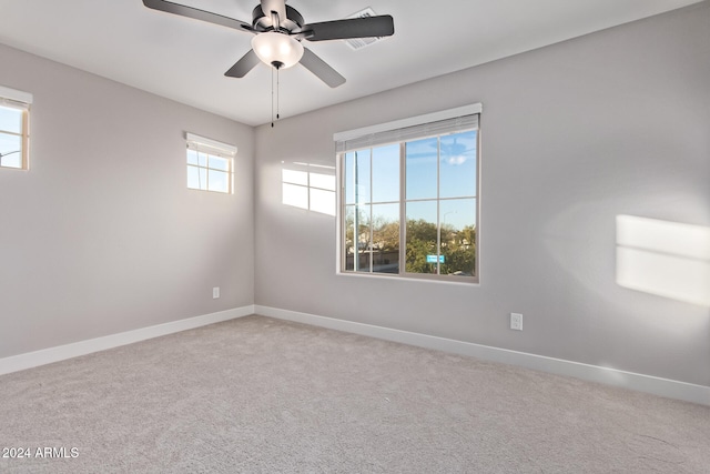 carpeted spare room with ceiling fan