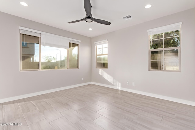 unfurnished room with light hardwood / wood-style floors, a wealth of natural light, and ceiling fan