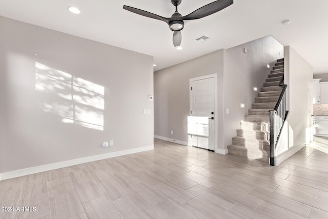 unfurnished living room featuring ceiling fan and light wood-type flooring