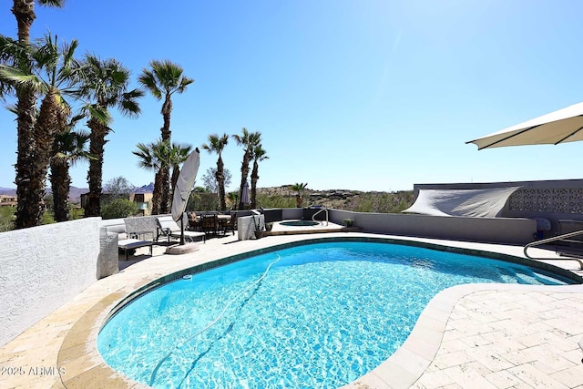 view of swimming pool featuring an in ground hot tub, a patio area, and a fenced in pool