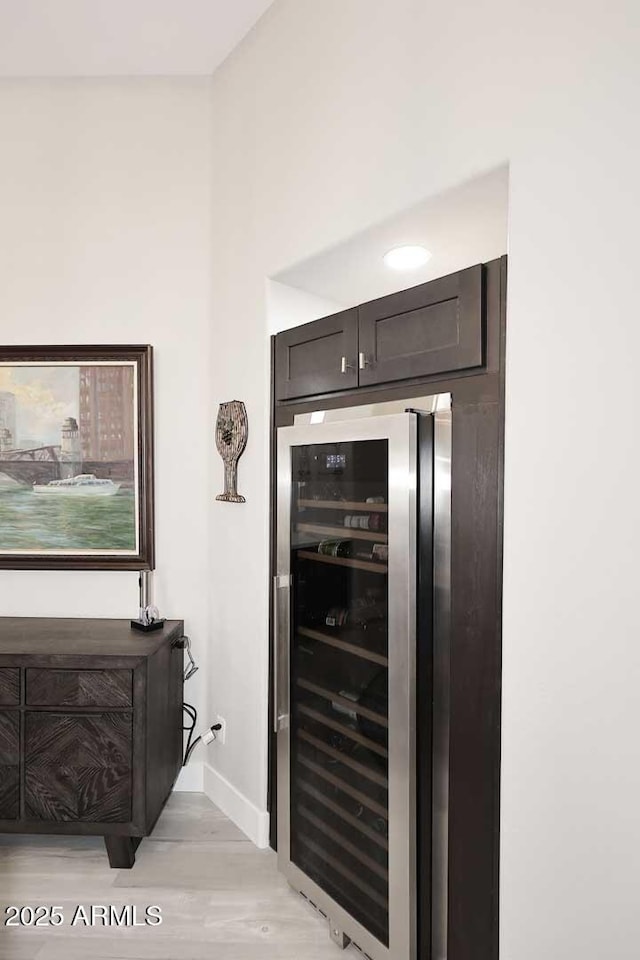 details featuring light wood-type flooring, baseboards, and beverage cooler