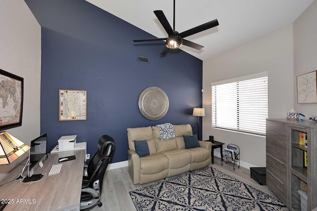 office area with wood finished floors, a ceiling fan, visible vents, baseboards, and vaulted ceiling