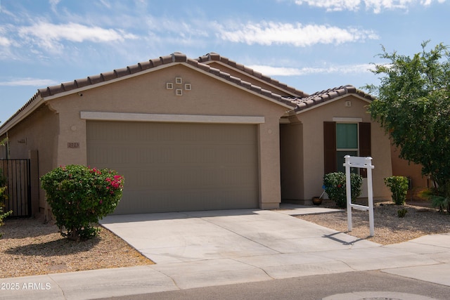 ranch-style house featuring driveway, stucco siding, a tiled roof, and an attached garage