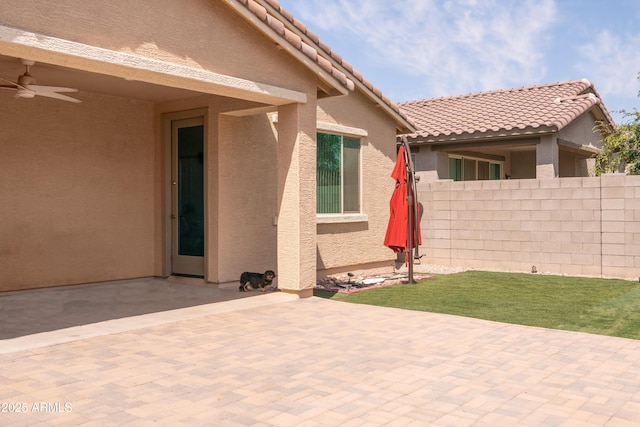 view of patio / terrace with a ceiling fan and fence