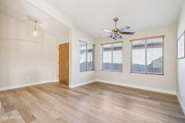 unfurnished room featuring ceiling fan, lofted ceiling, and light hardwood / wood-style flooring