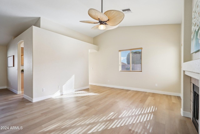 unfurnished living room with ceiling fan, light hardwood / wood-style floors, and vaulted ceiling