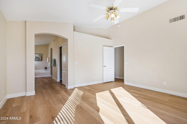 spare room featuring hardwood / wood-style flooring, ceiling fan, and lofted ceiling