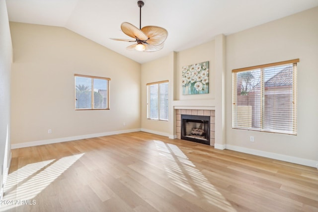 unfurnished living room with ceiling fan, a healthy amount of sunlight, lofted ceiling, and light wood-type flooring