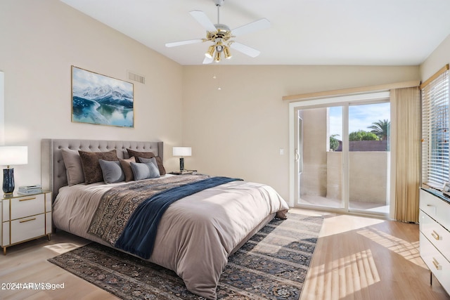 bedroom with access to exterior, light wood-type flooring, vaulted ceiling, and ceiling fan