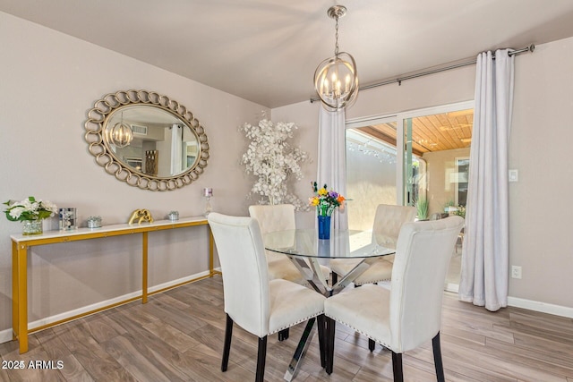 5913 E Thomas Rd, Scottsdale, AZ 85251 - dining space with a chandelier, wood finished floors, and baseboards