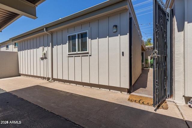 5913 E Thomas Rd, Scottsdale, AZ 85251 - view of property exterior with board and batten siding and a patio
