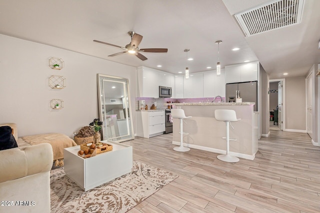 5913 E Thomas Rd, Scottsdale, AZ 85251 - living area with a ceiling fan, light wood-style flooring, baseboards, and recessed lighting