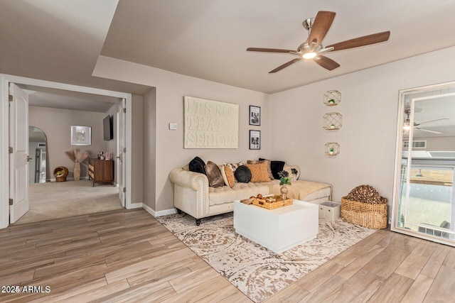 5913 E Thomas Rd, Scottsdale, AZ 85251 - living area with a ceiling fan, wood finished floors, and arched walkways