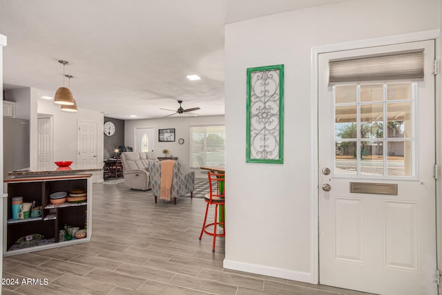 foyer with light hardwood / wood-style flooring and ceiling fan