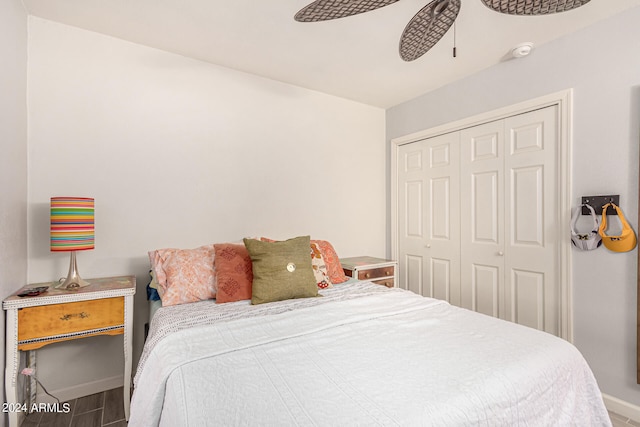 bedroom featuring hardwood / wood-style floors, a closet, and ceiling fan